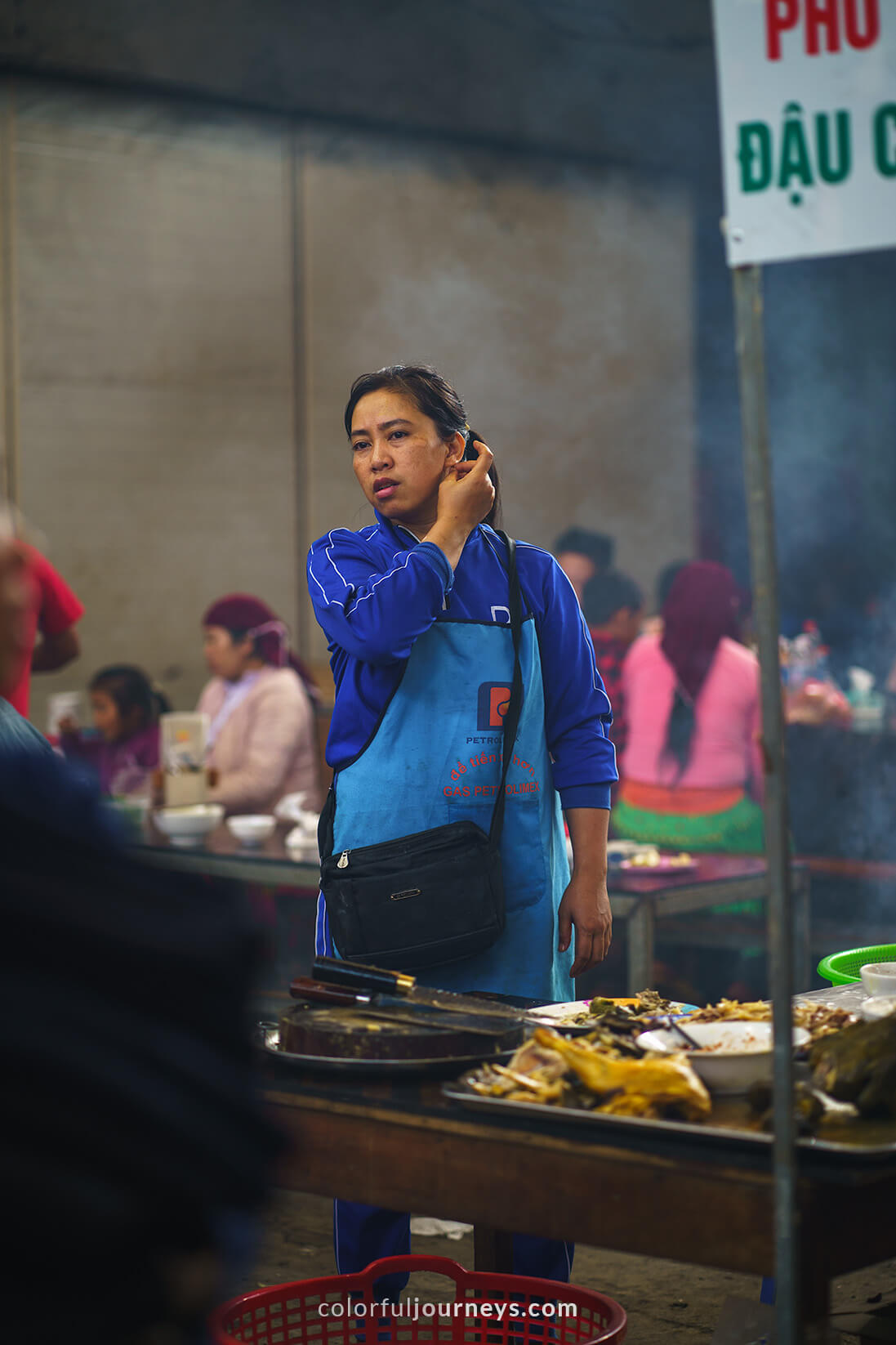 A woman sells noodles at Meo Vac Market, Vietnam