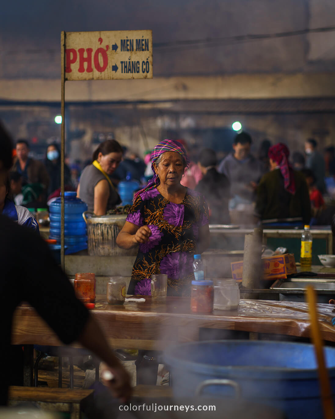 A vendor sells good at Meo Vac Market, Vietnam