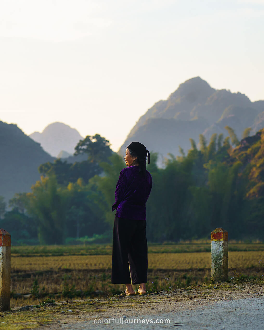 A woman with mountains in the background. Cao Bang, Vietnam