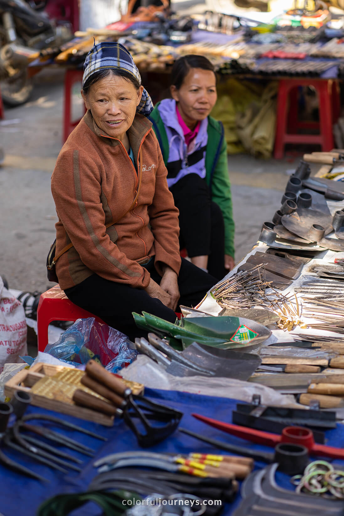 A woman sells knives at a market in Cao Bang, Vietnam