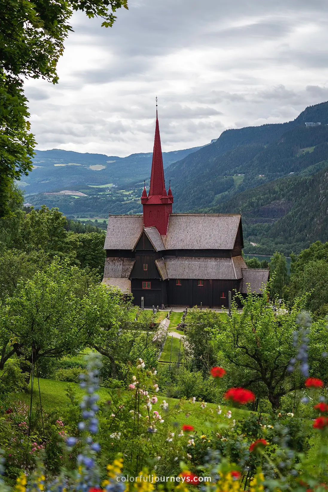 An old Stave Church in Norway with flowers in the foreground