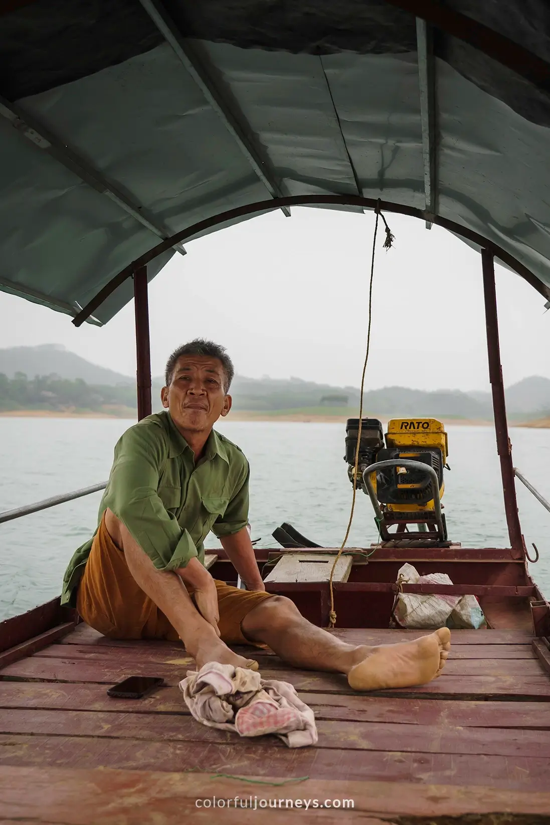 A man drives a boat on Thac Ba Lake, Vietnam