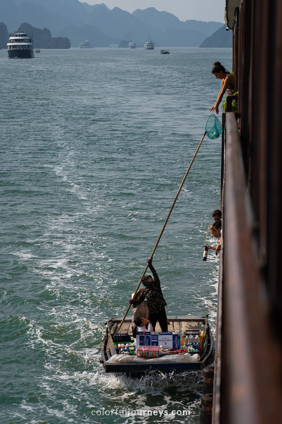 People sell goods to a cruise-ship in Halong Bay, Vietnam