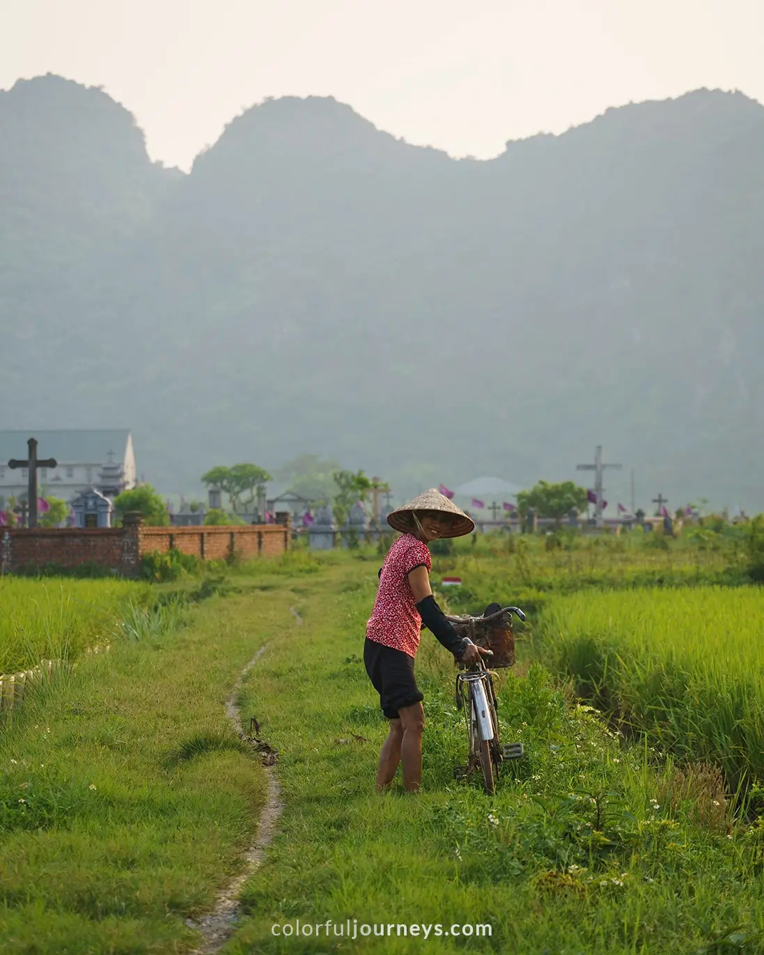 A woman with a bicycle in Ninh Binh, Vietnam