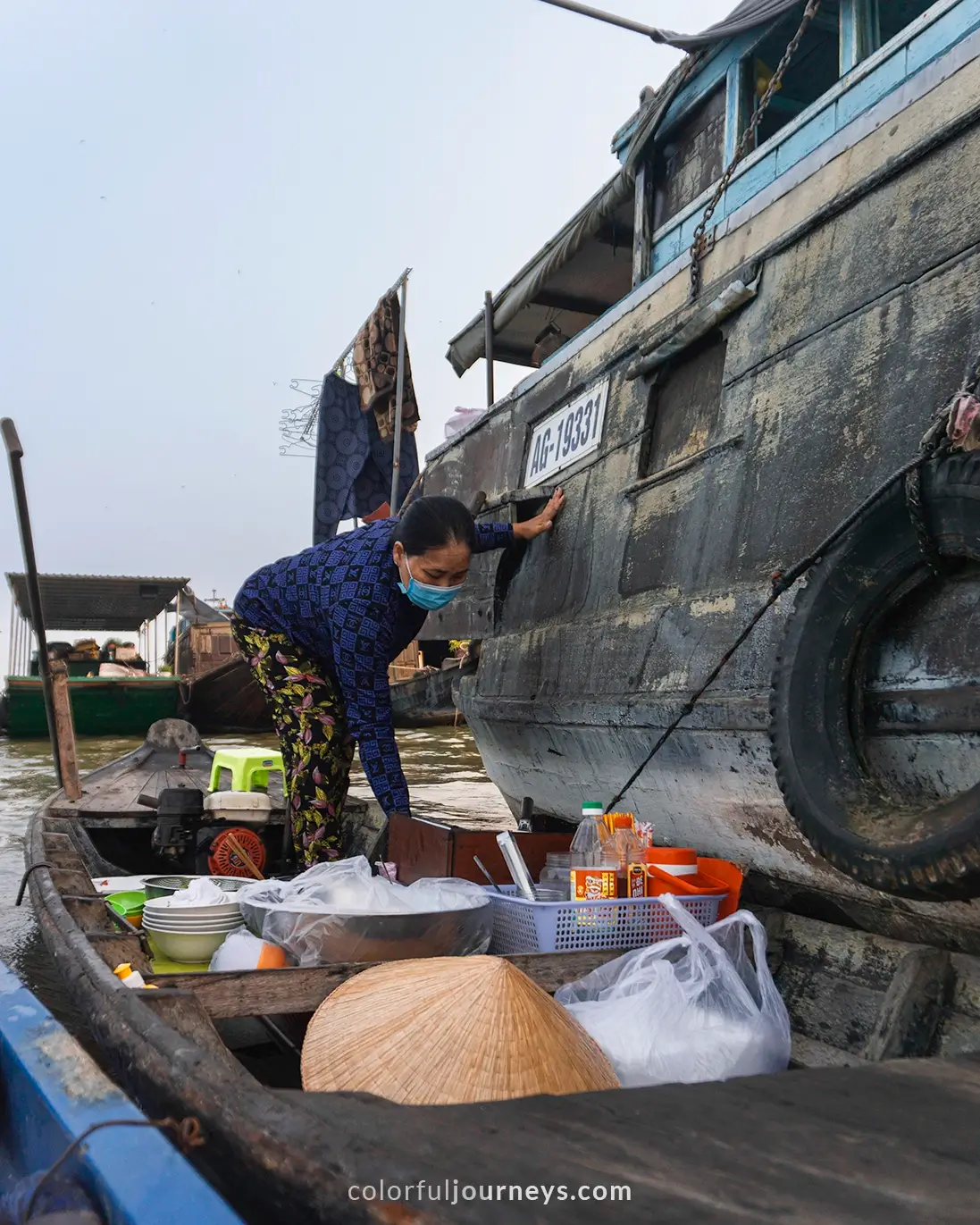 A woman sells noodles out of her boat in Vietnam