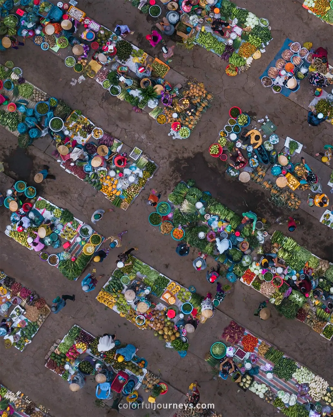 People selling goods at a market in Vietnam