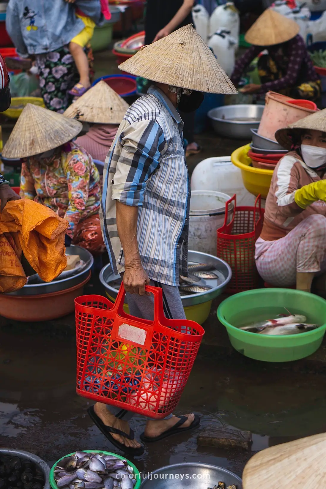 People selling goods at a market in Vietnam