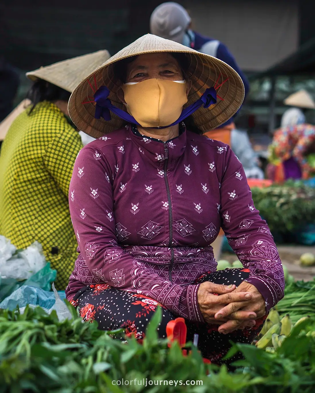 A woman selling goods at a market in Vietnam