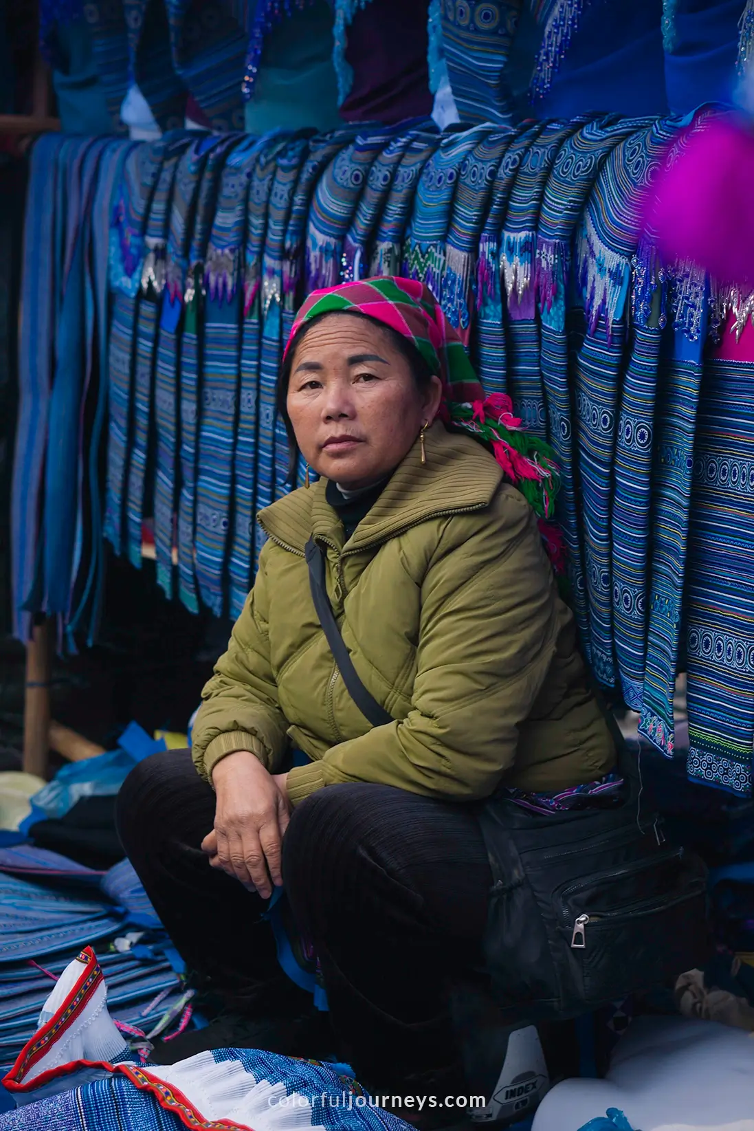A woman sells colorful clothes at Bac Ha market, Vietnam