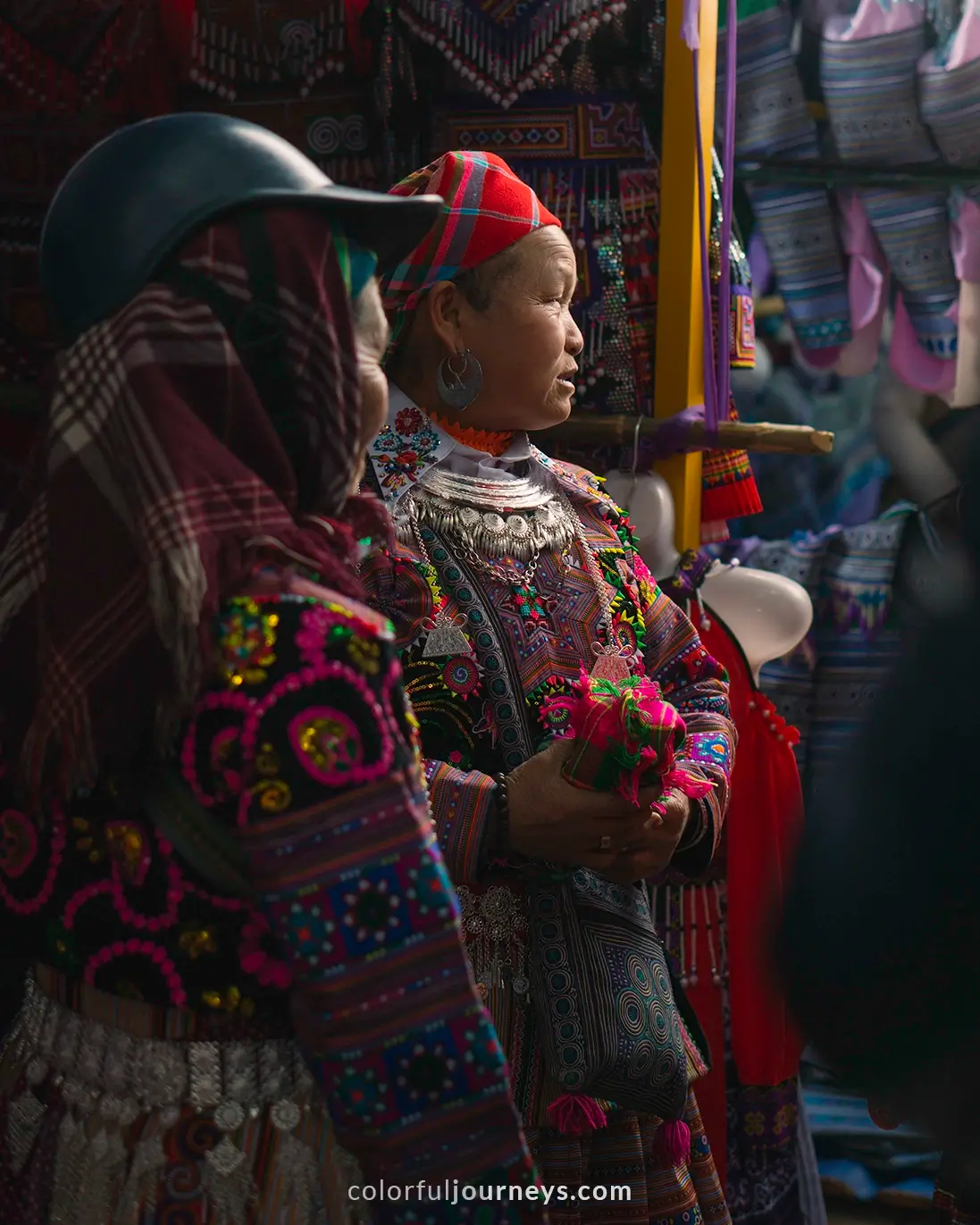 Women dressed in colorful traditional clothes at Bac Ha market