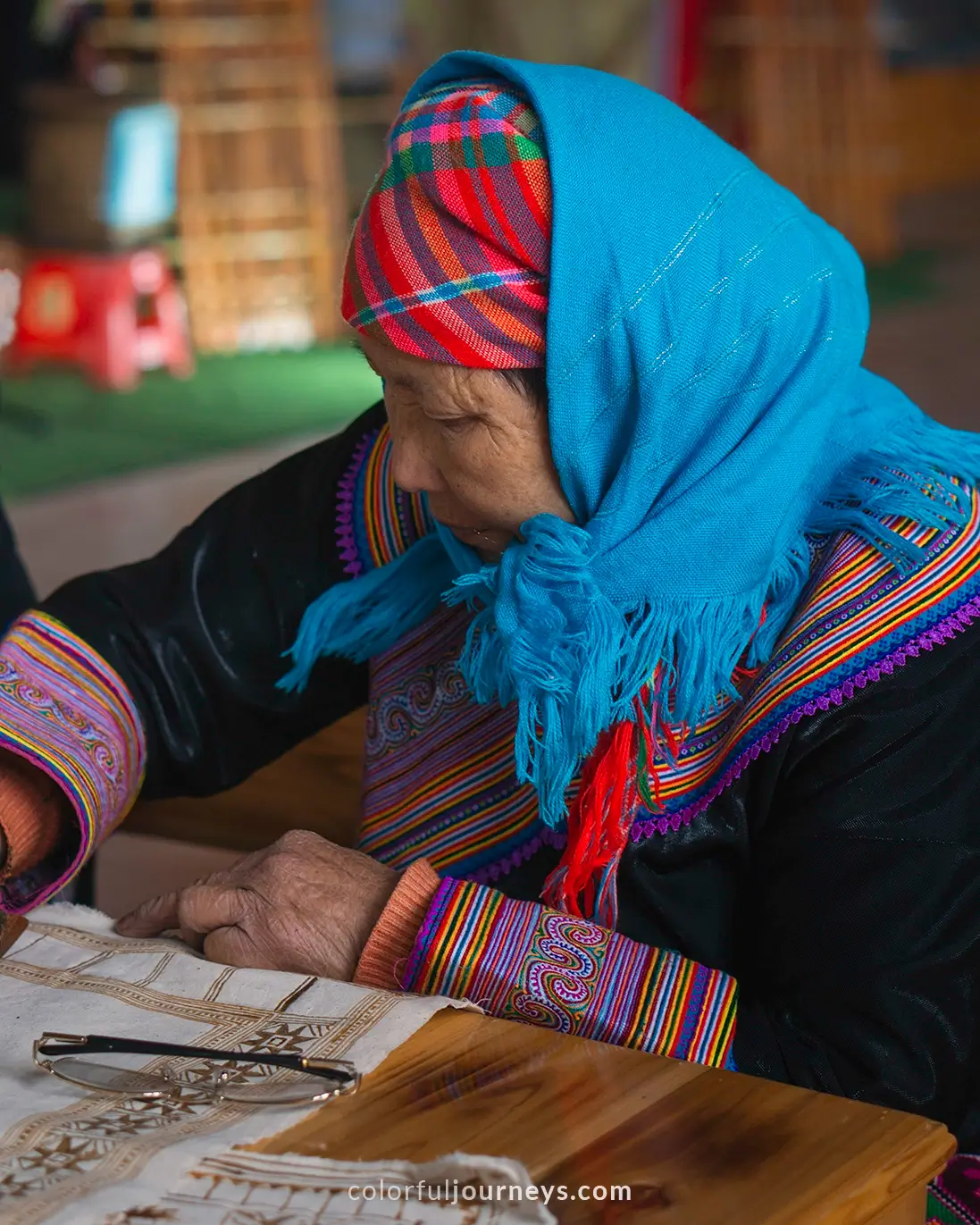 A woman sells colorful clothes at Bac Ha market, Vietnam