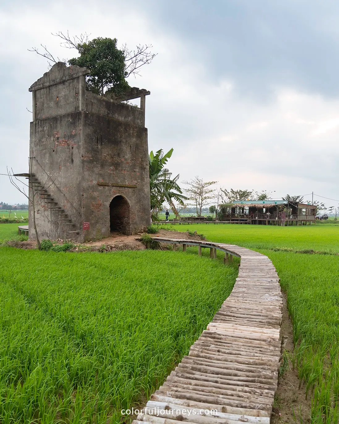 A brick tower surrounded by rice paddies in Hoi An, Vietnam