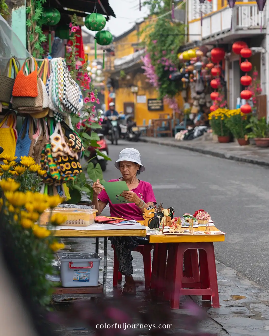 A woman selling cards on the streets of Hoi An, Vietnam