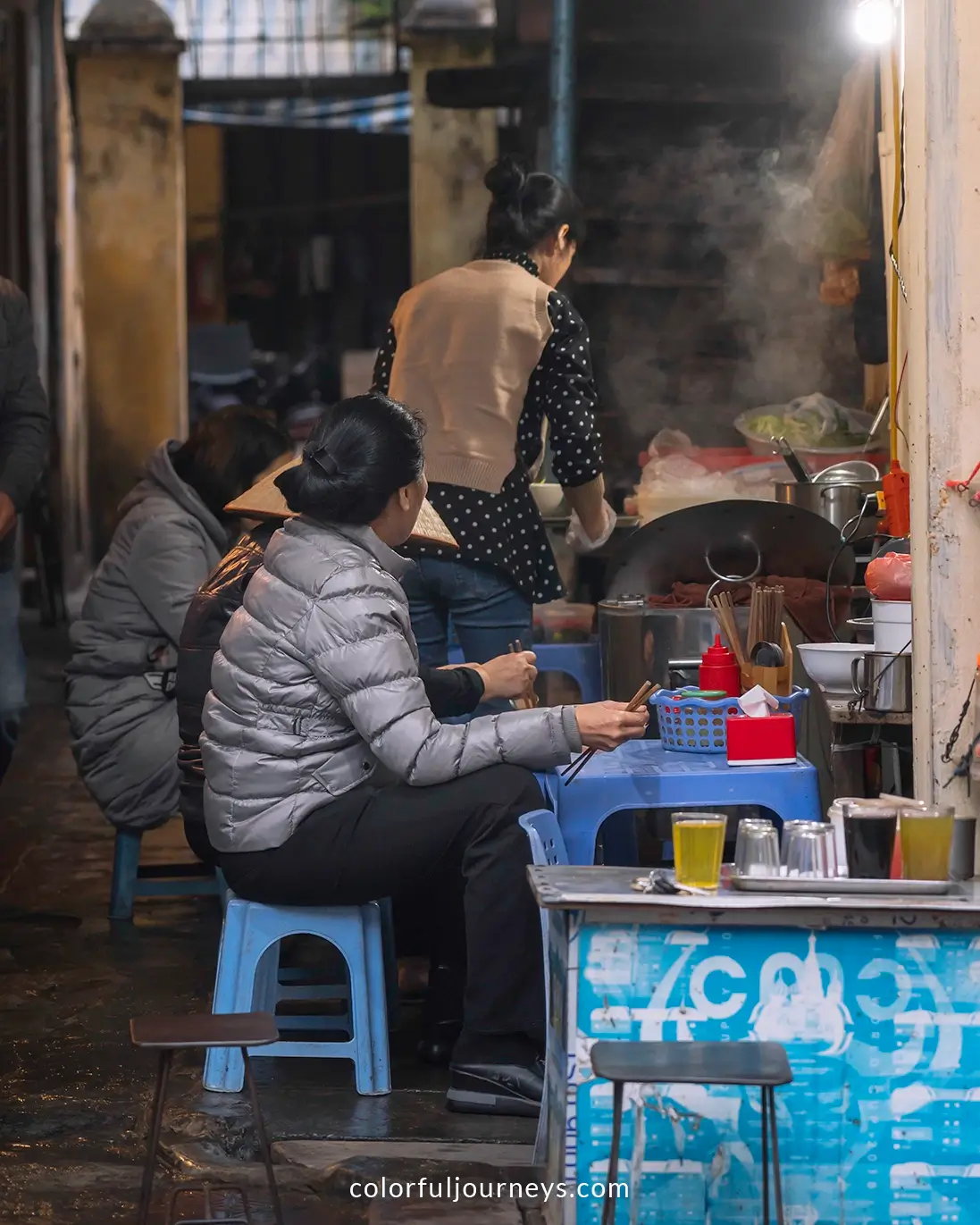 A woman cooking street food in Hanoi, Vietnam