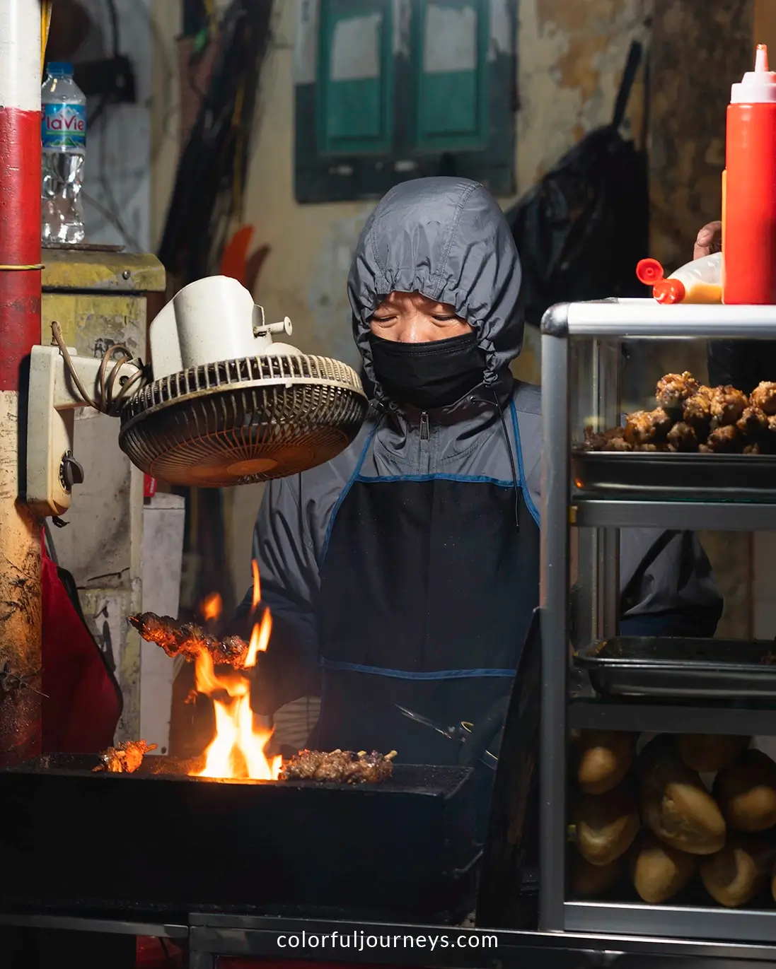 A woman cooking street food in Hanoi, Vietnam