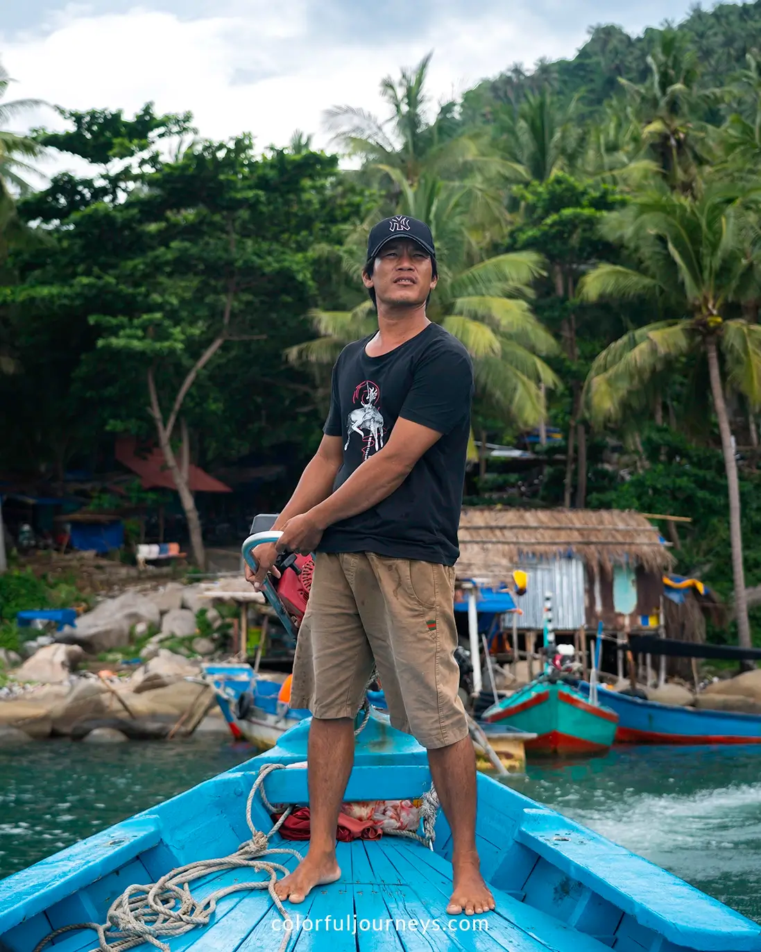 A man stands on a boat near Hon Son Island, Vietnam