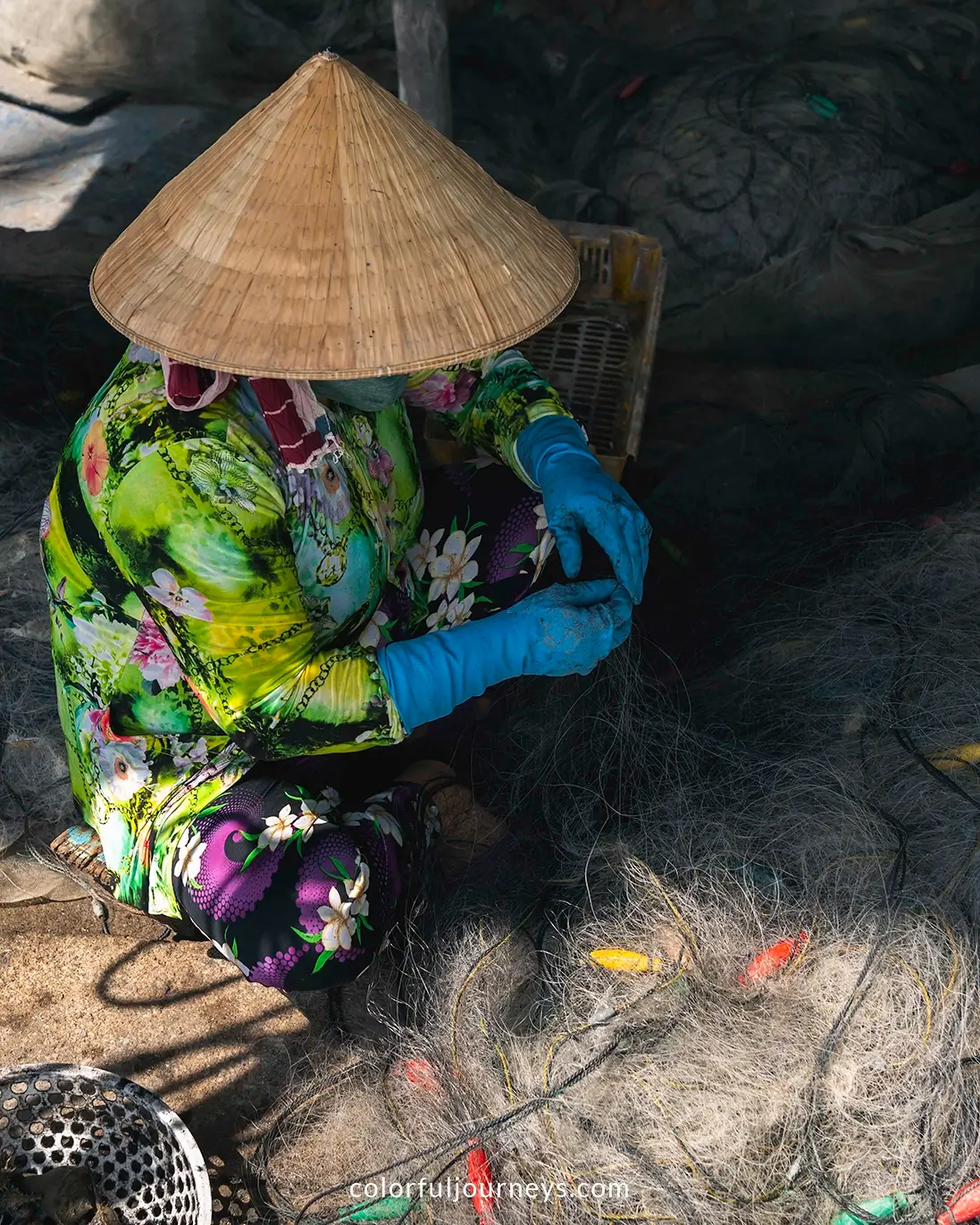 A woman mending fishing nets on Hon Son Island, Vietnam
