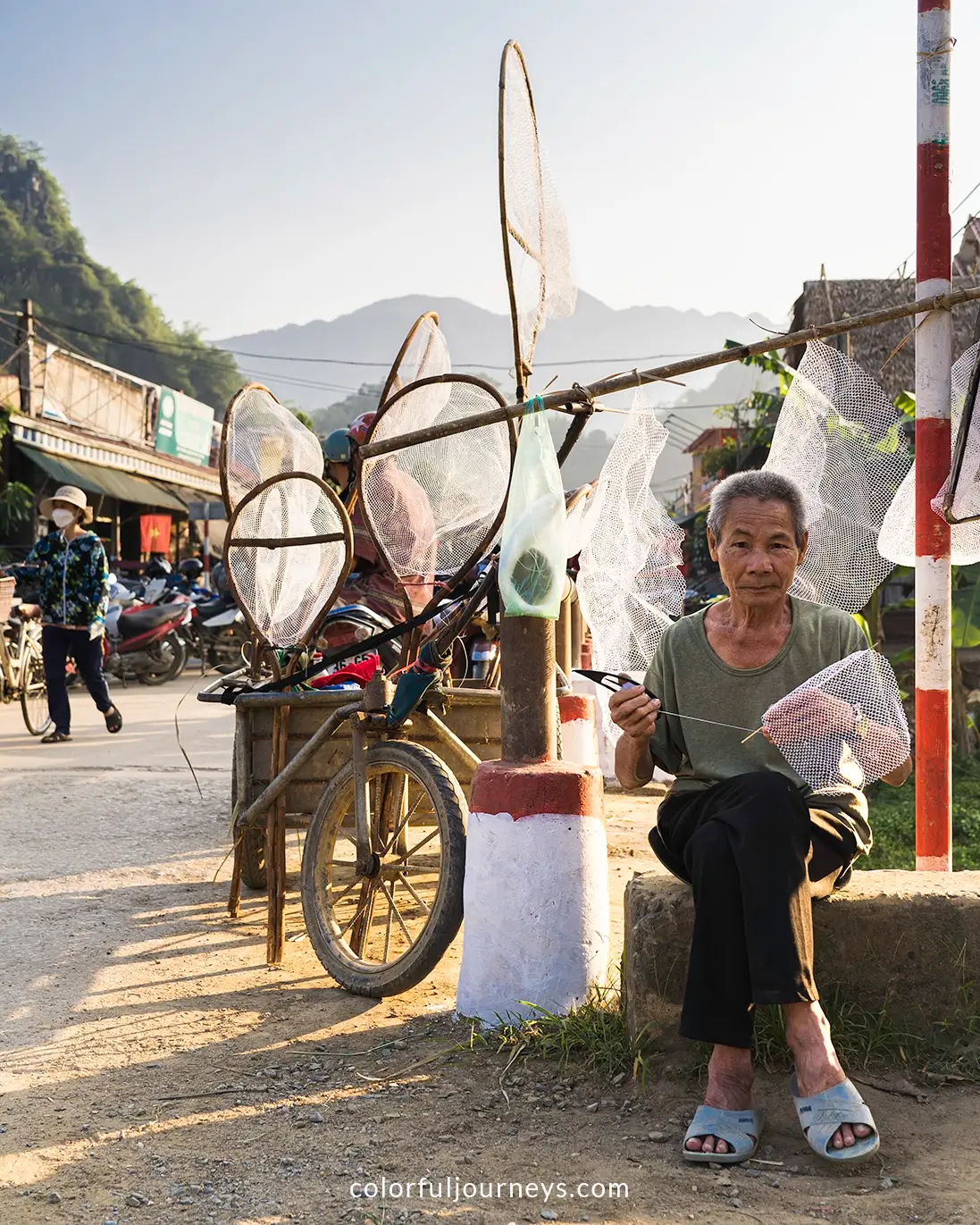 A man sells butterfly nets at a market in Pu Luong, Vietnam