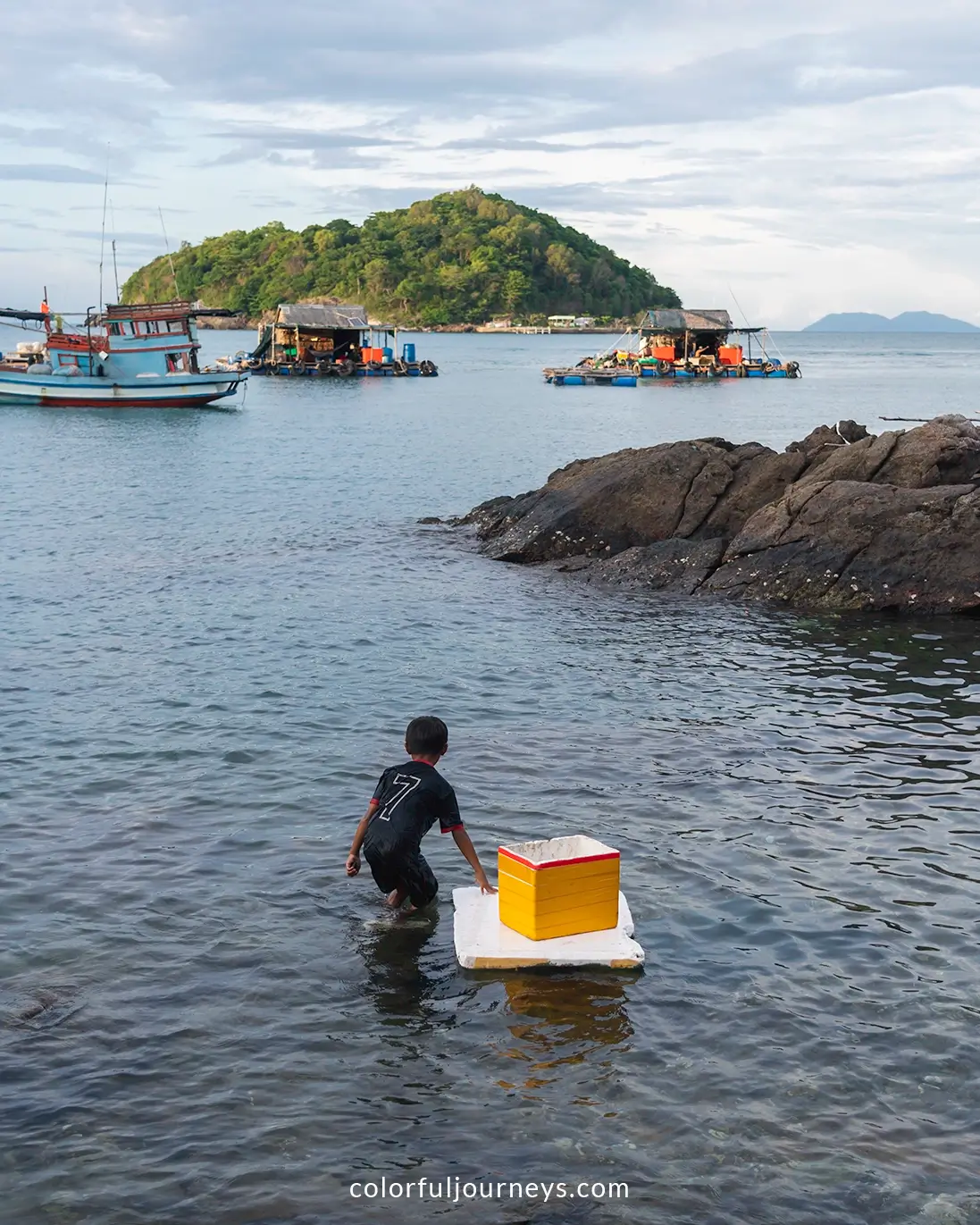 Children are swimming near a fishing village on Nam Du Island, Vietnam