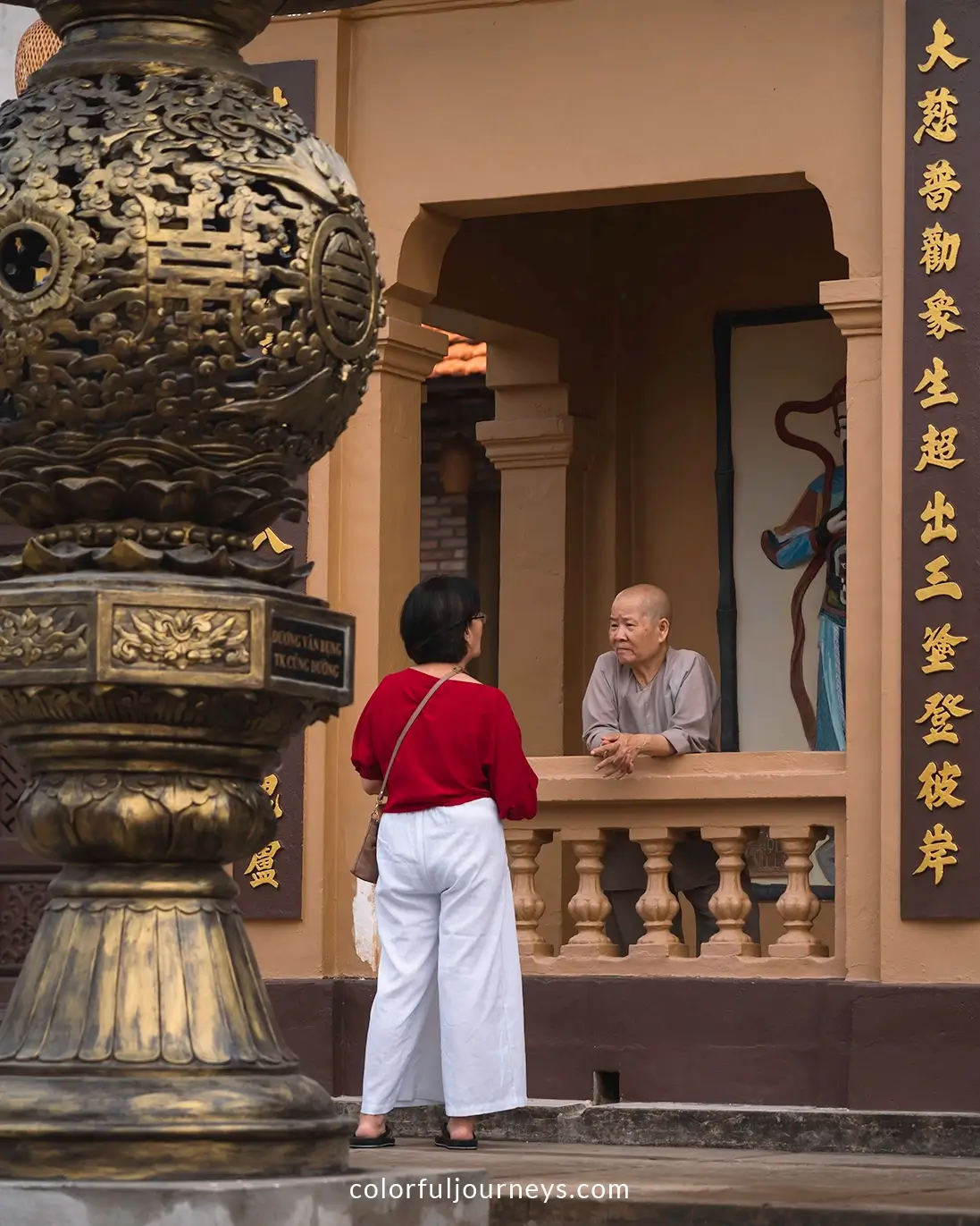 A monk talks to a woman at Phu Dung pagoda in Ha Tien, Vietnam