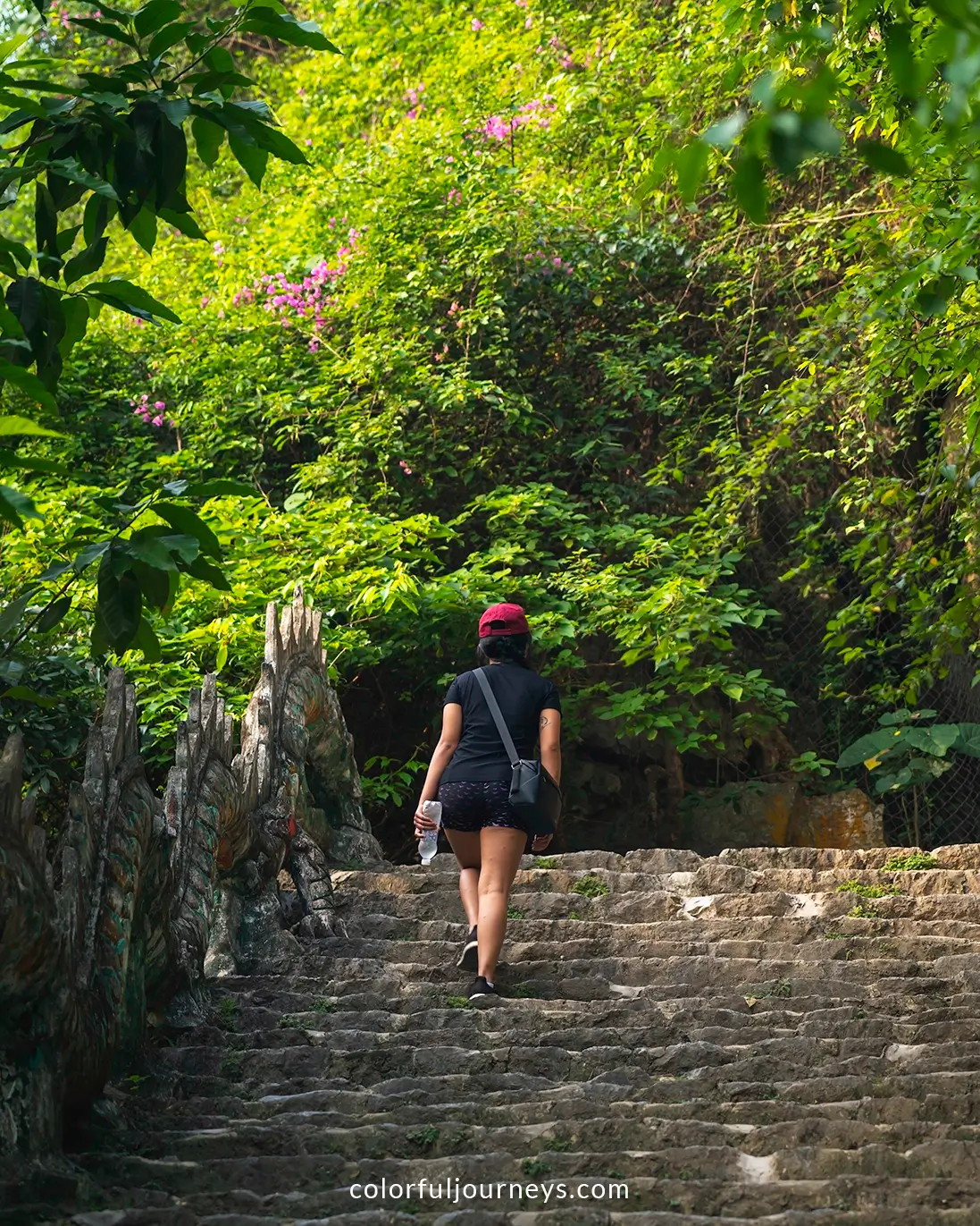 A woman walks up stairs leading up to Hang Mua viewpoint in Ninh Binh, Vietnam