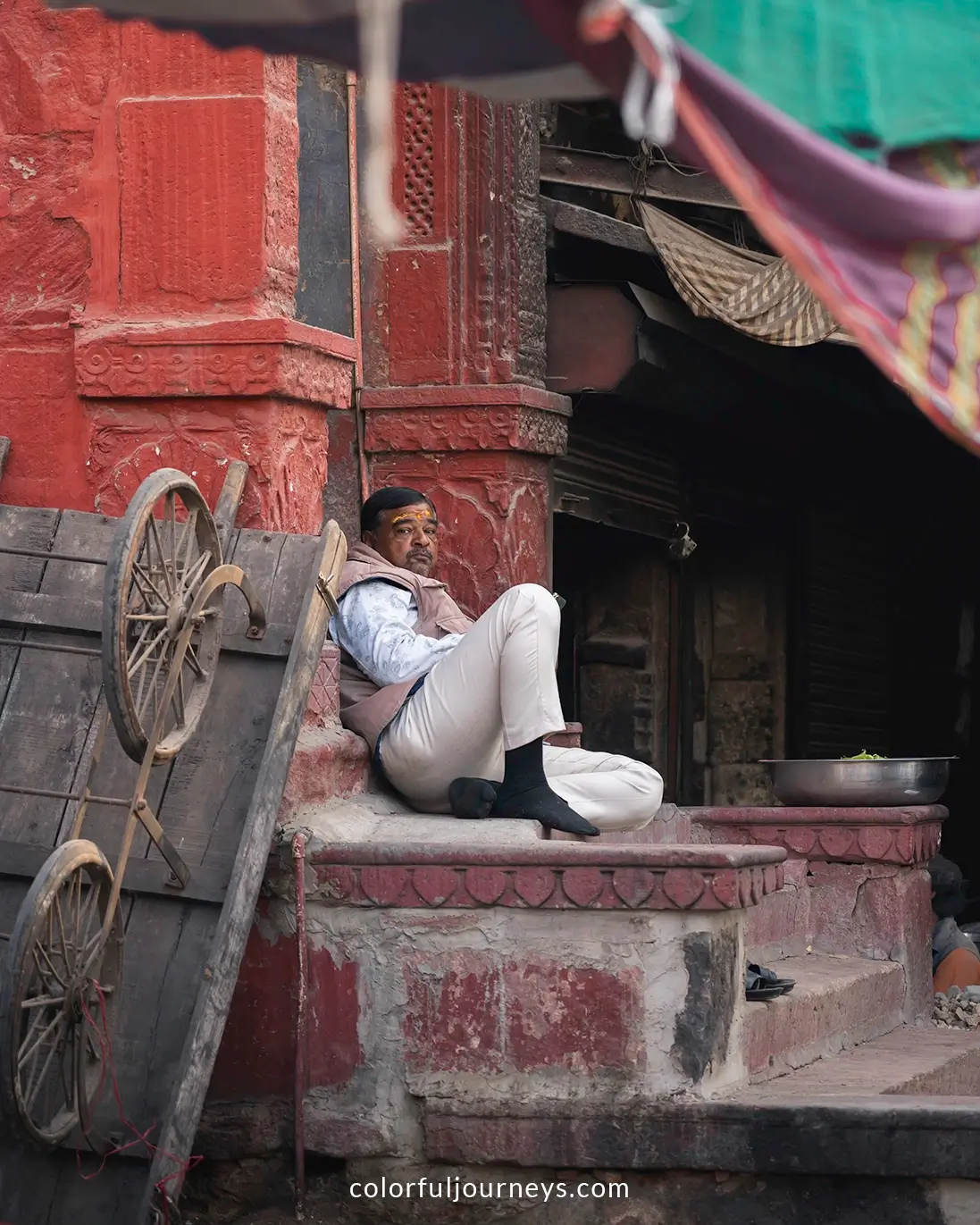 A man sits on the streets of Jodhpur, India