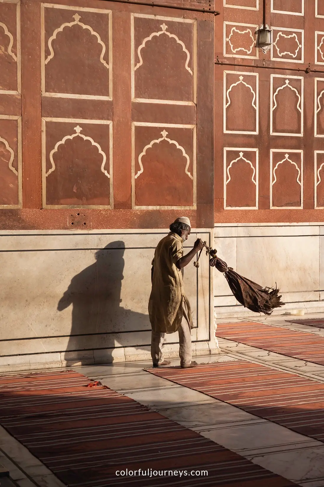 A man sweeps the floor at Jama Masjid in Delhi, India