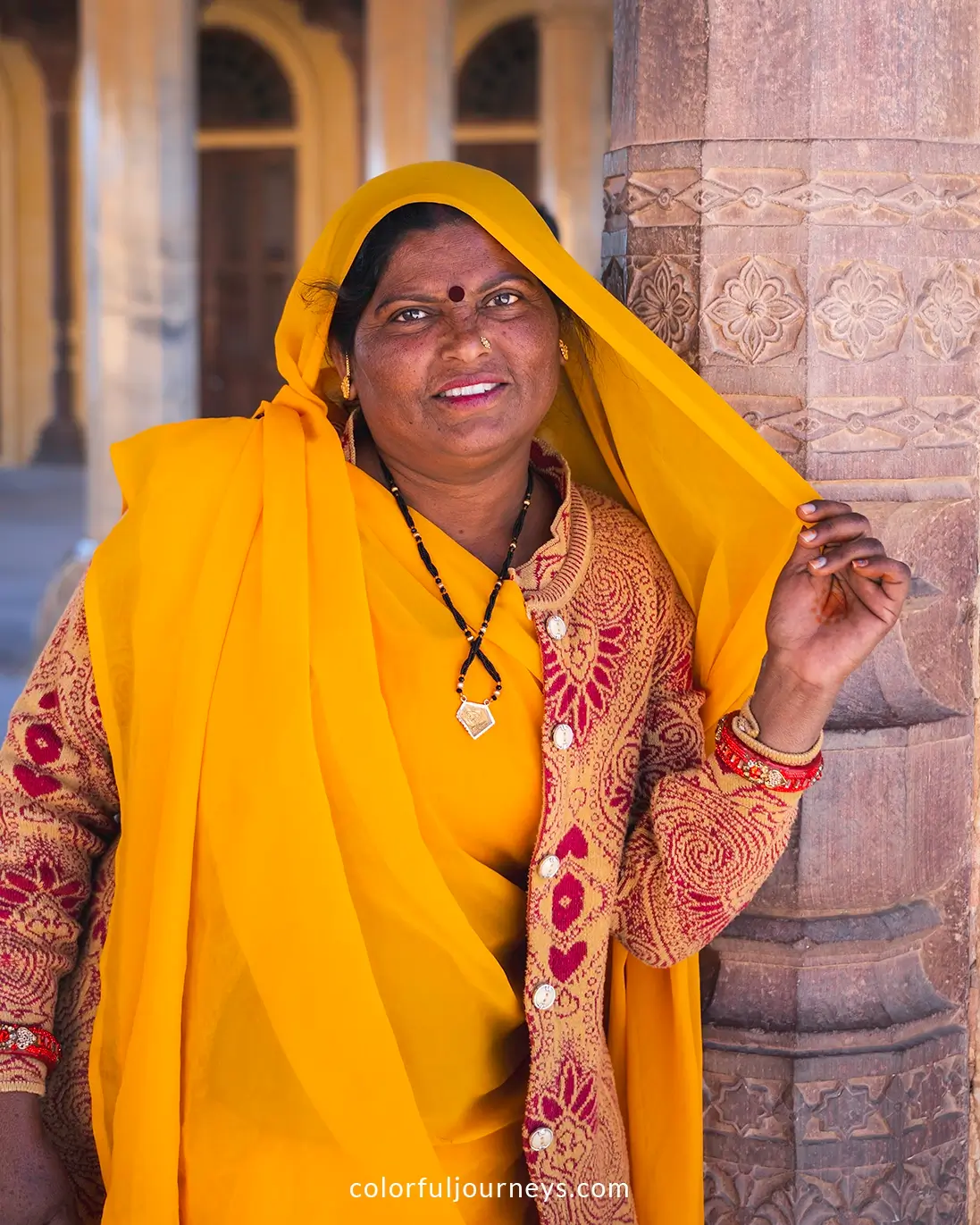 A woman in a yellow sari at the Amber Fort, India