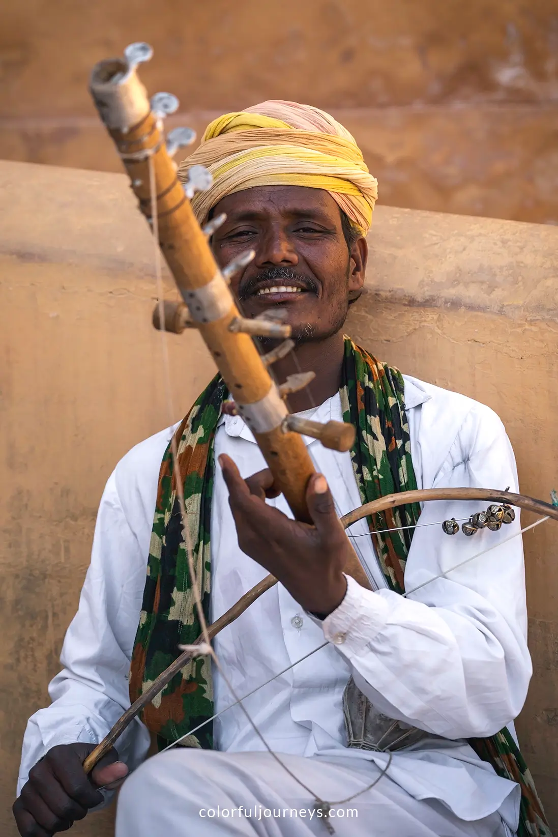 A man plays an instrument in Jaipur, India