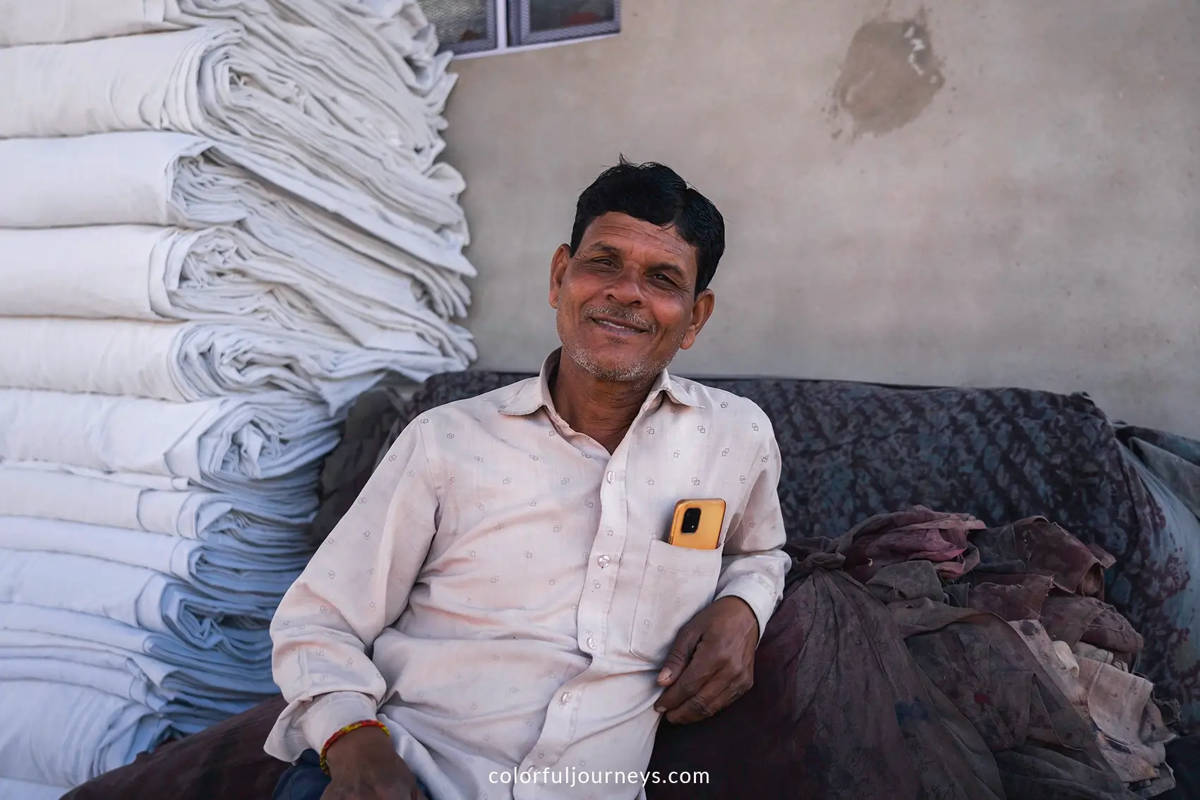 A man smiles at the camera in Sanganer, India
