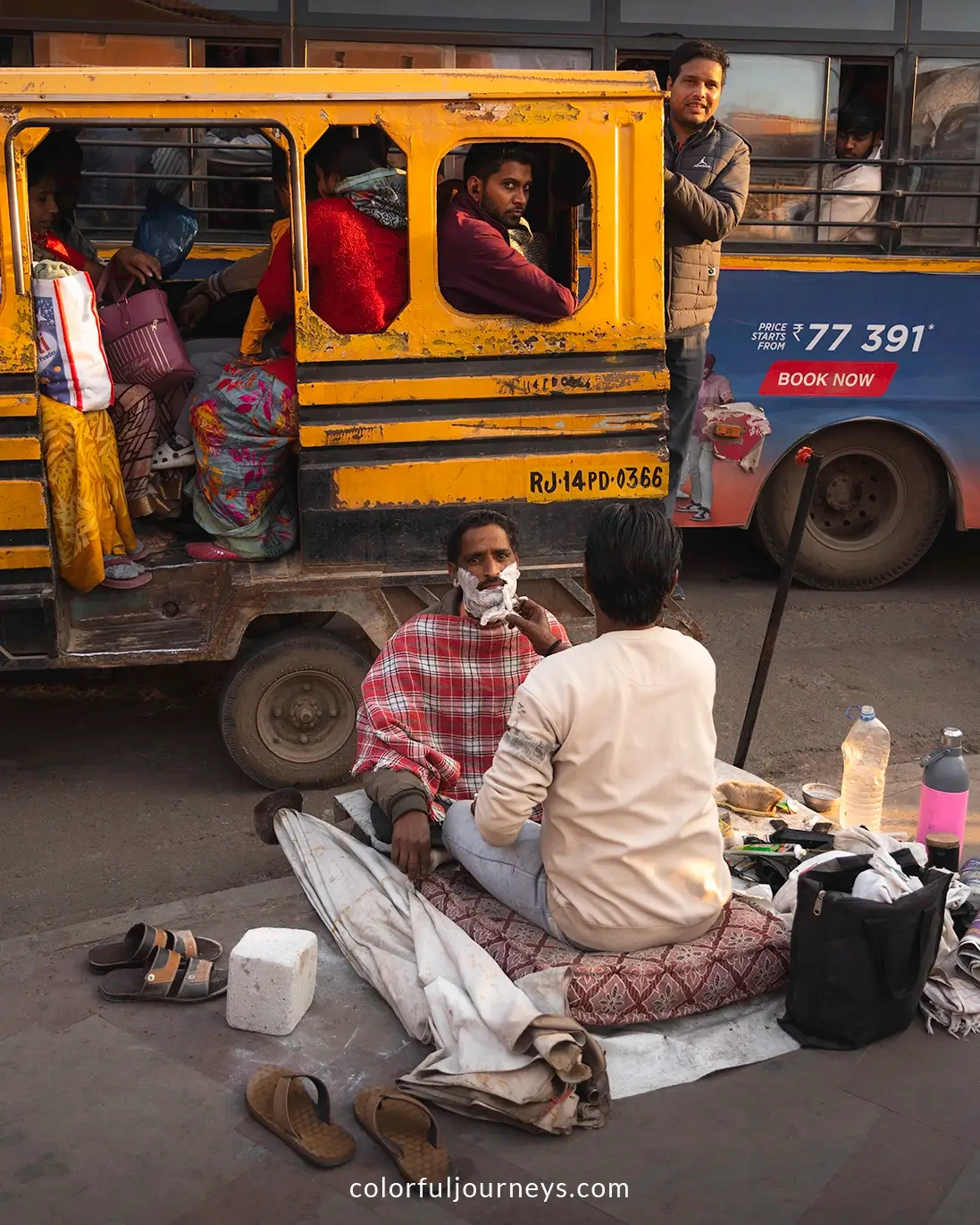 A man getting a shave on the streets of Jaipur, India