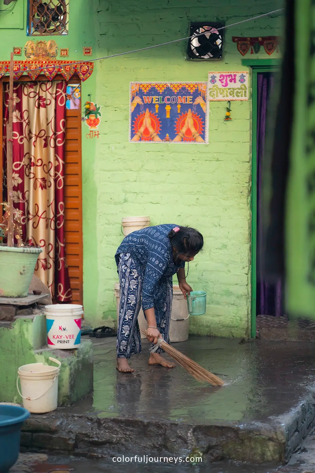 A woman sweeps the floor at the Yamuna Ghat in Delhi, India