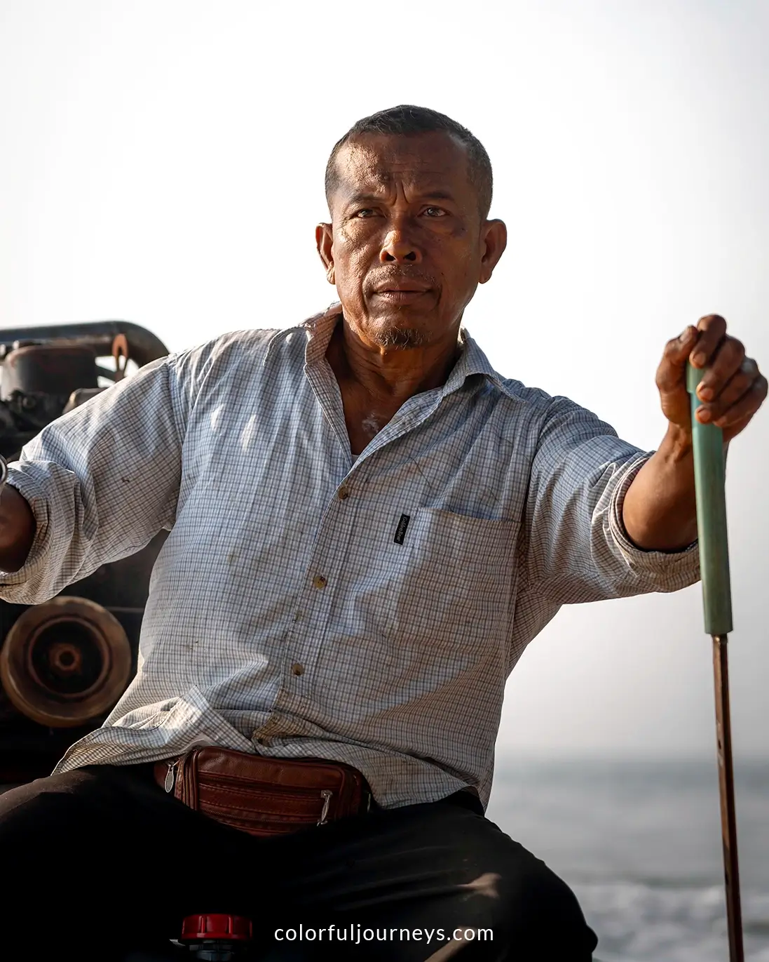 A man drives a boat in Phang Nga Bay, Thailand