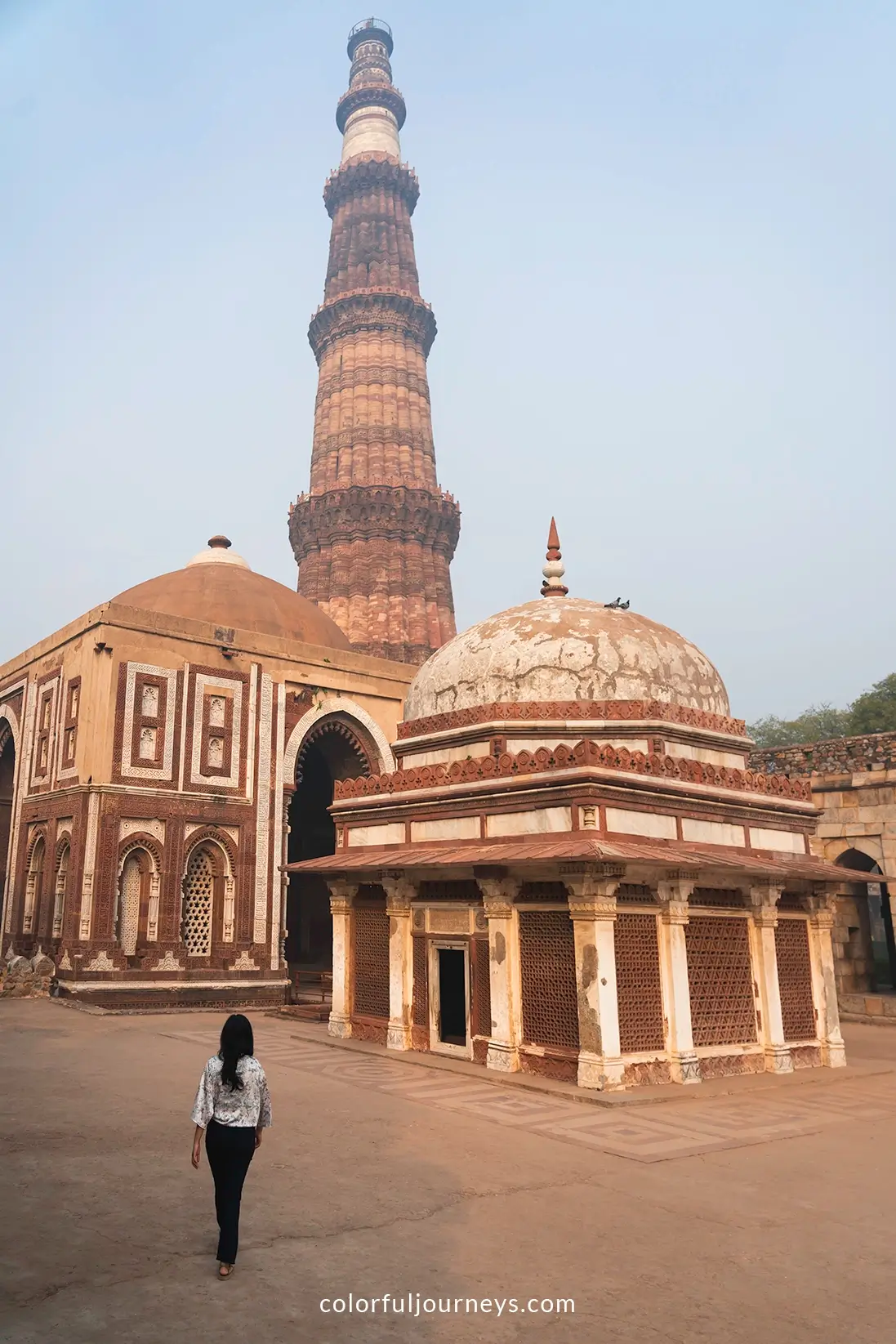 A woman walks around the Qutub Minar complex in Delhi, India