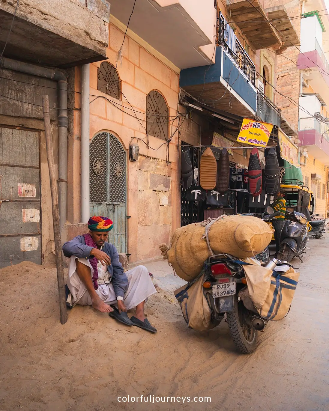 A man transports big bags on his motorbike in Jodhpur, India