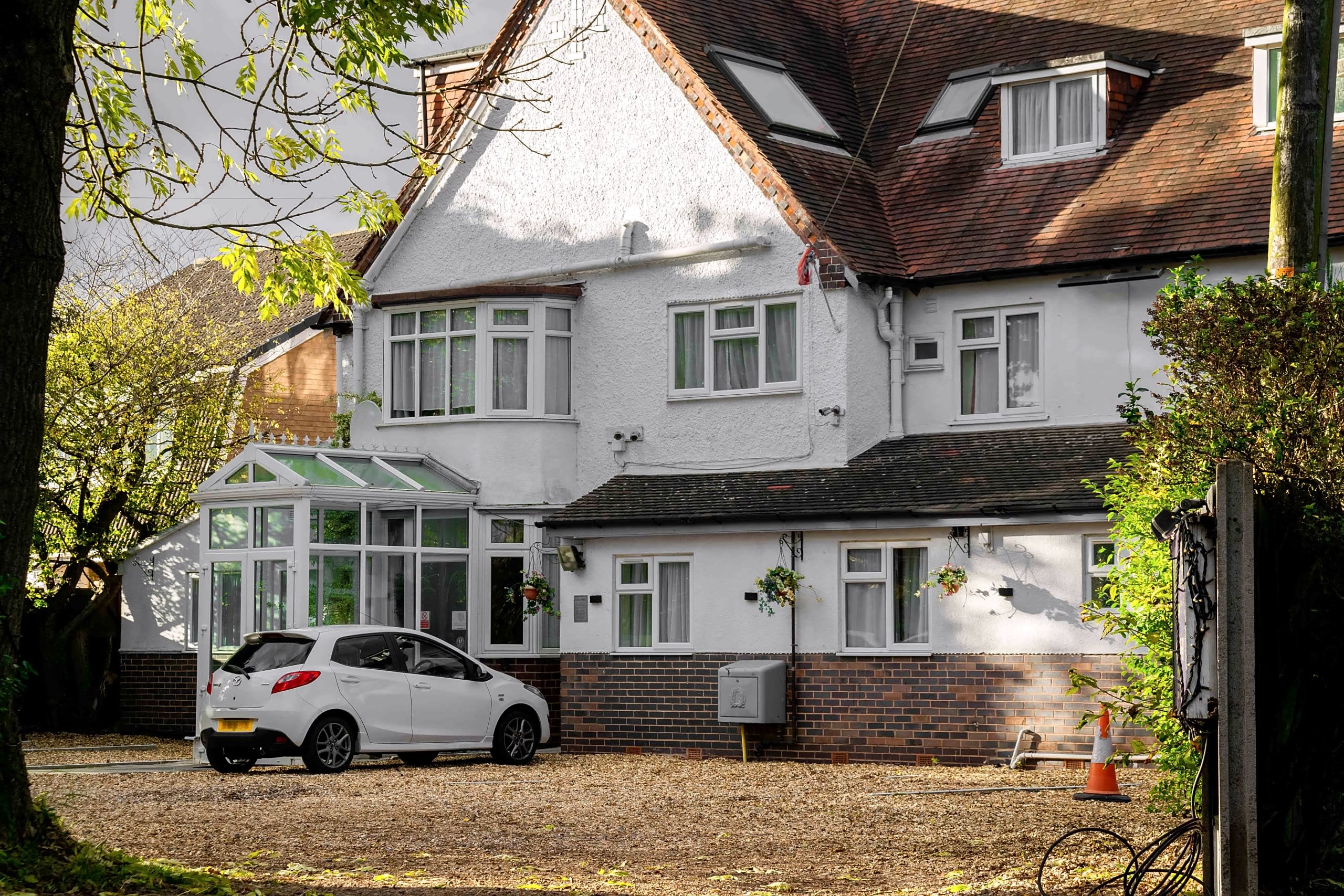 The front of Royal Square Hotel, a white Edwardian-style building with a conservatory entrance and front car park