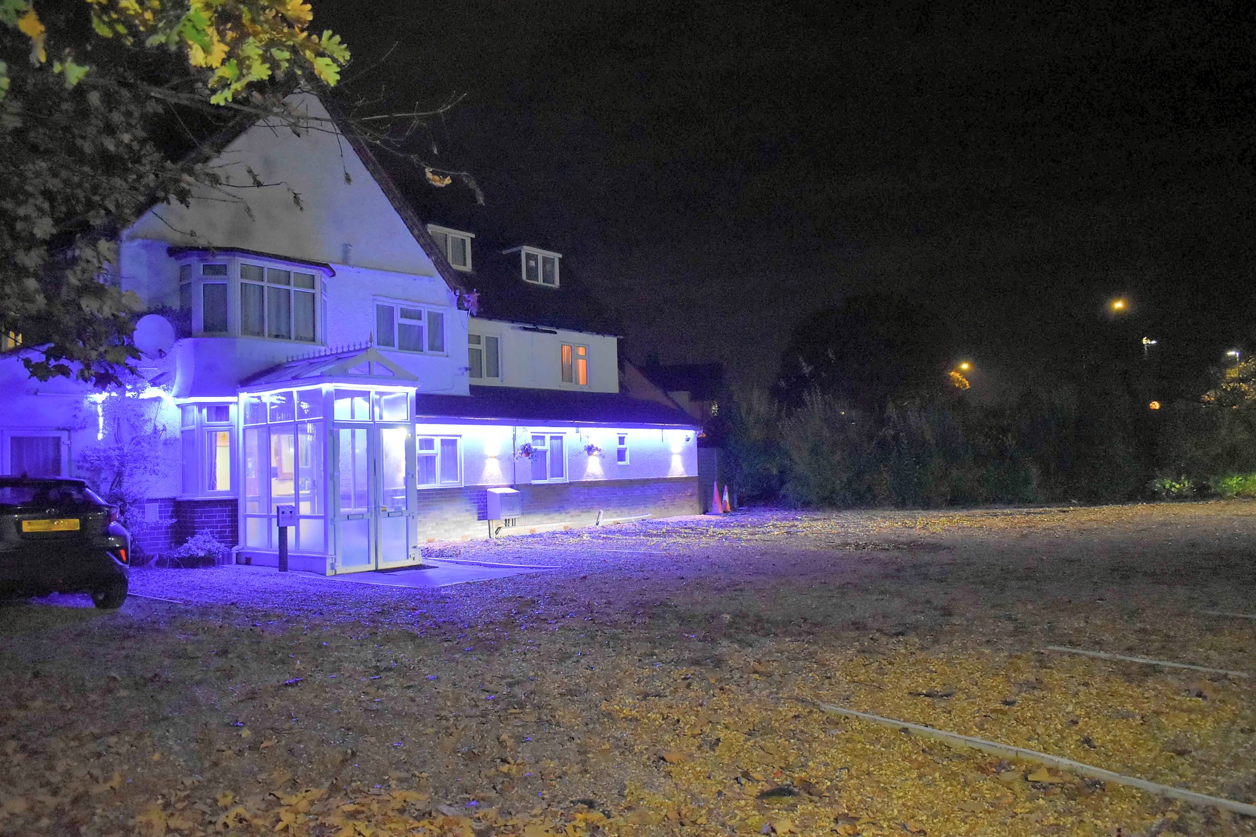 Royal Square Hotel at night, with blue lighting along the front