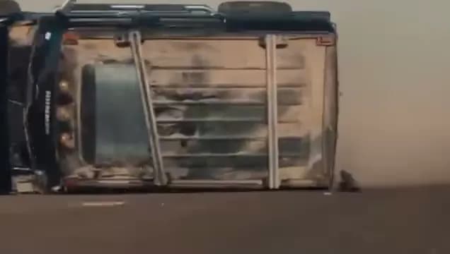 The same Hummer H2 on its side, seconds later