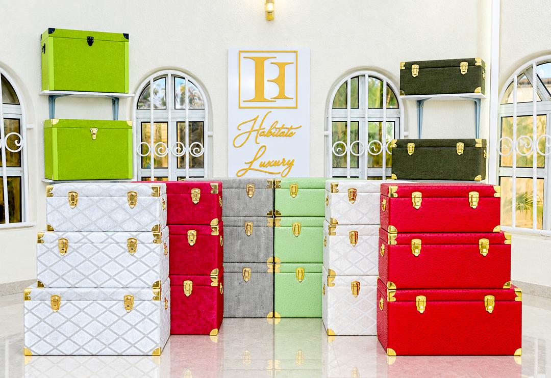 Stacks of premium gift boxes and trunks in red, green, grey and white quilted finishes