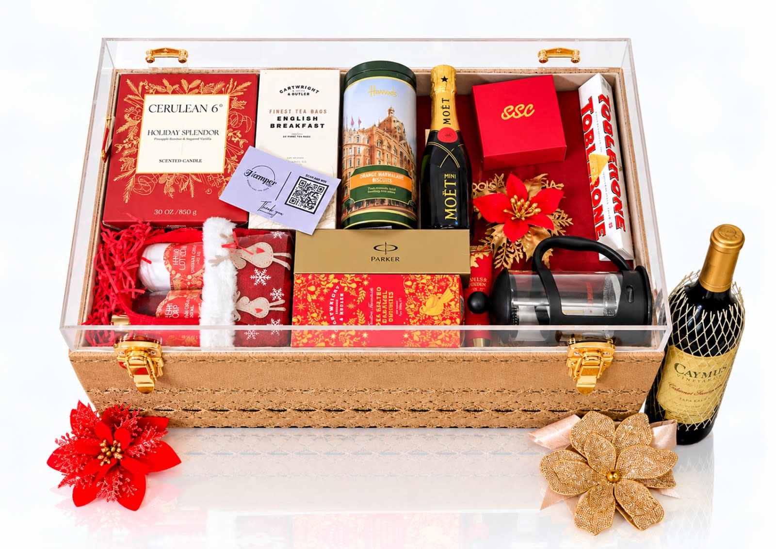 A curated gift hamper in a clear keepsake case, filled with wine, champagne, chocolates and treats