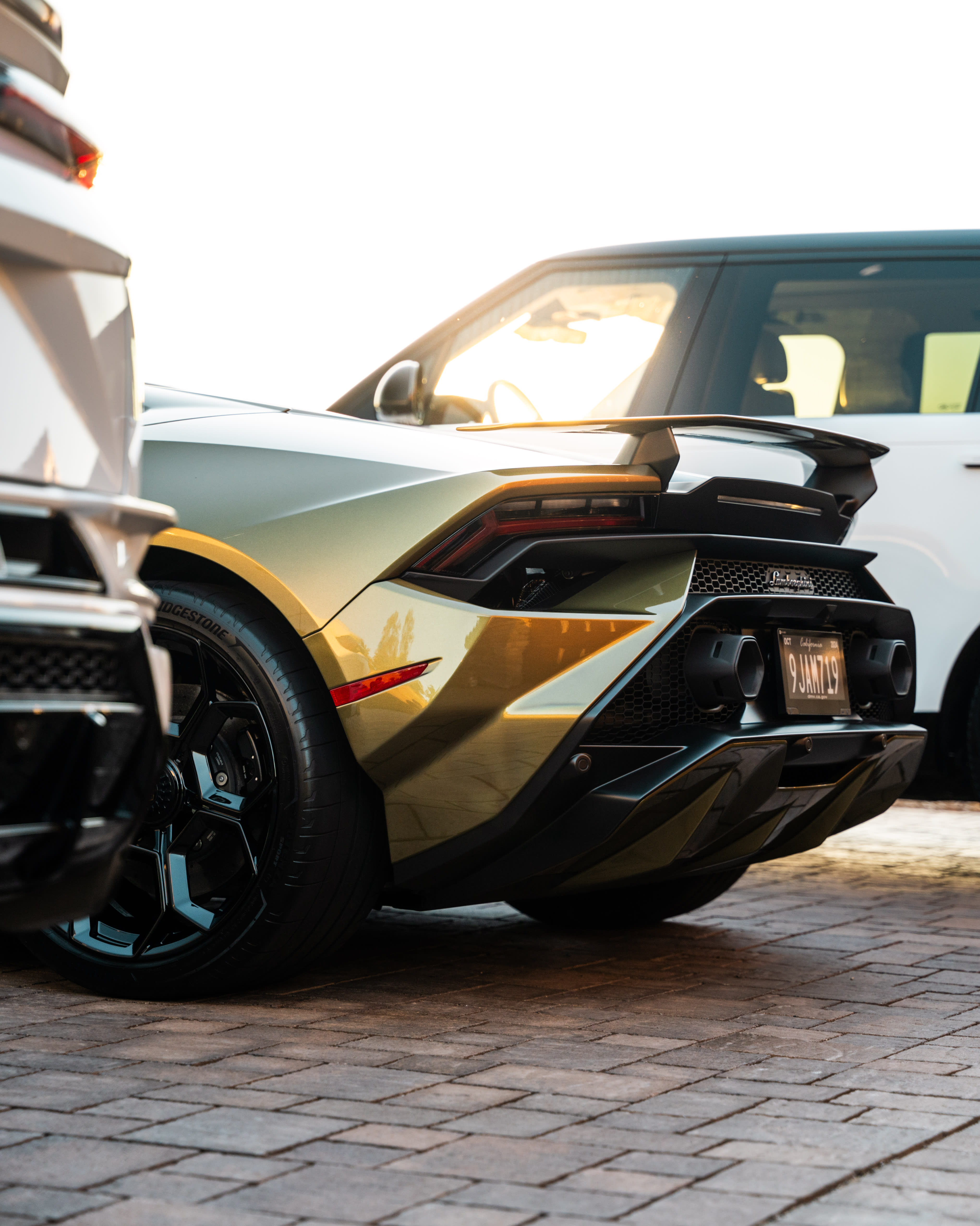 Gold Huracan rear close-up - exhaust and spoiler detail at sunset