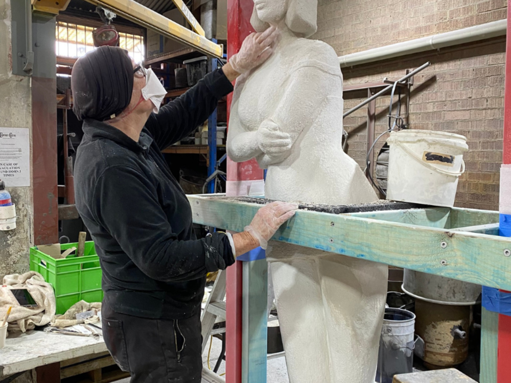 The artist making adjustments to the original sculpture