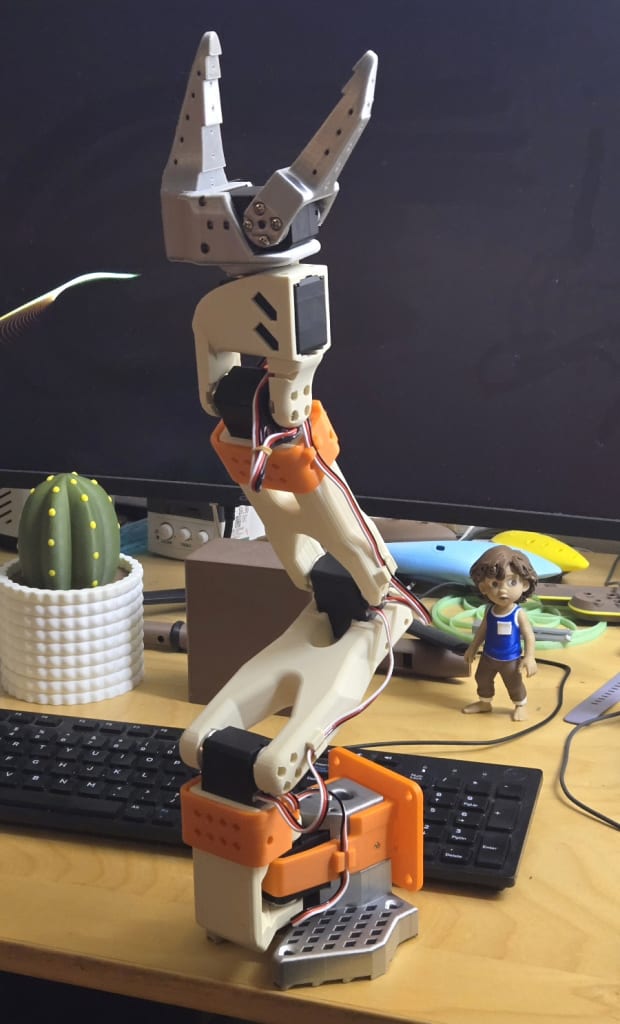 My orange, silver, and cream colored SO-101 6-DOF robot arm.