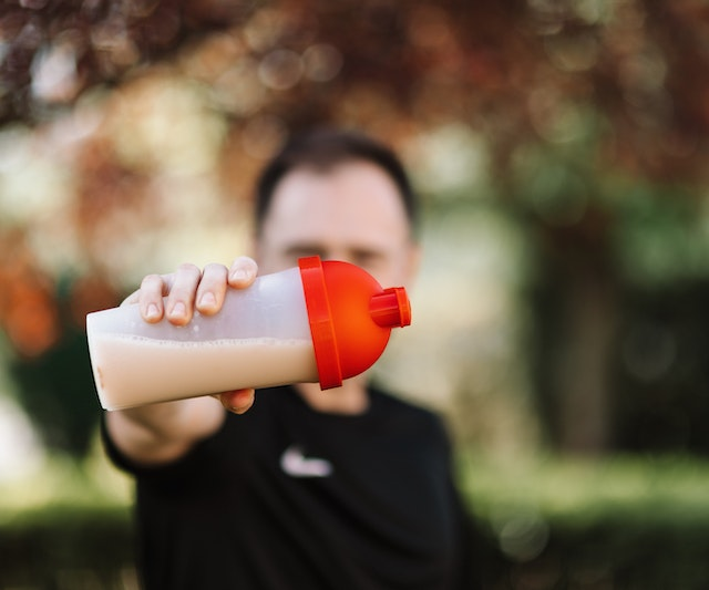 Man holding a protein shake in his hand