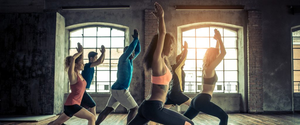 A group of six people doing yoga in the studio