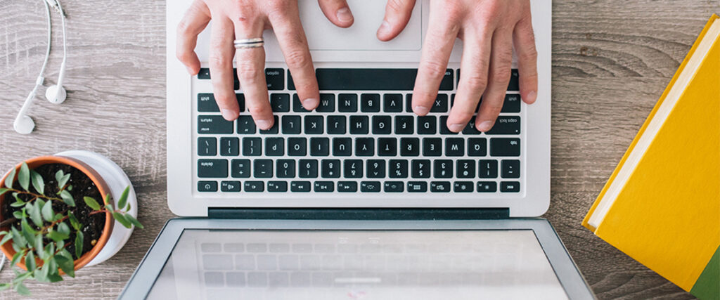 Two hands typing computer's keyboard