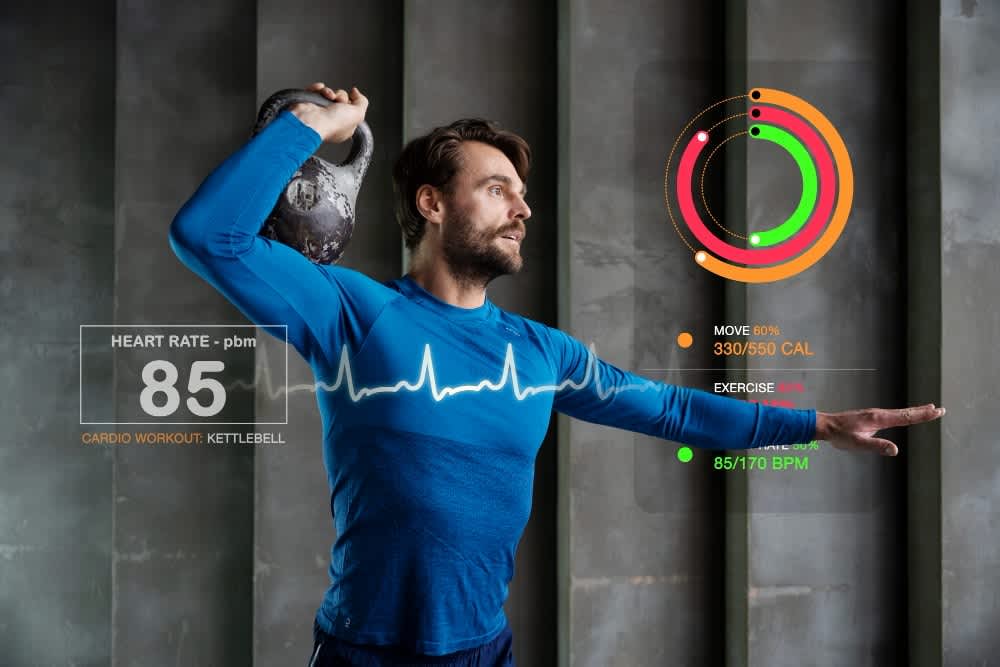 A man in a blue athletic shirt performing a kettlebell workout, with digital health data like heart rate and calorie count displayed alongside him.