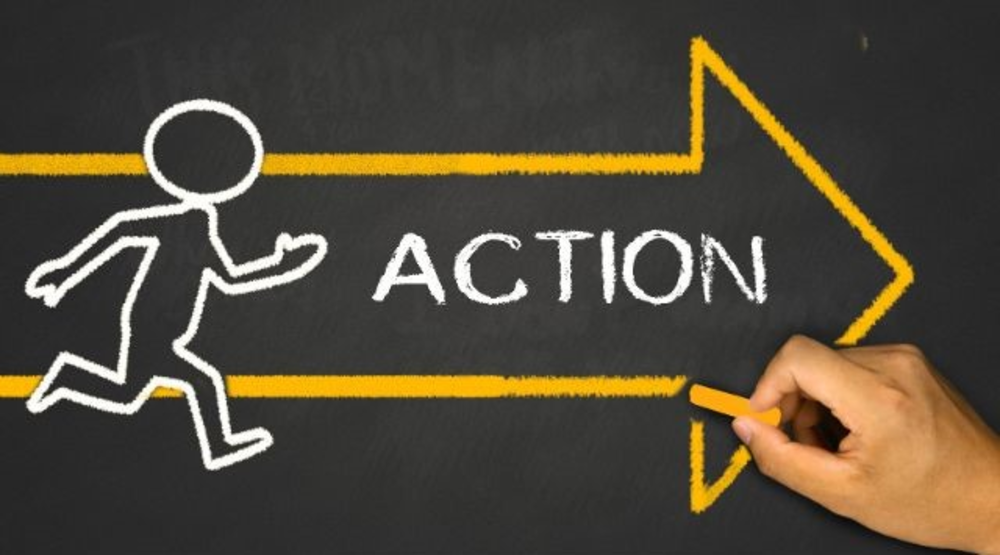 Hand draws a drawing with yellow chalk which says Action and arrow with running person