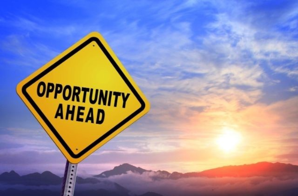 Yellow road sign Opportunity ahead, mountains on the background