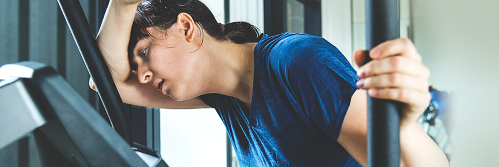 Woman looks tired after having a workout in the gym